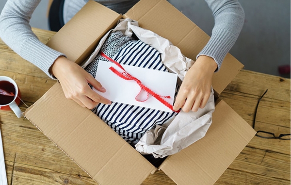 A woman opening a cardboard gift box