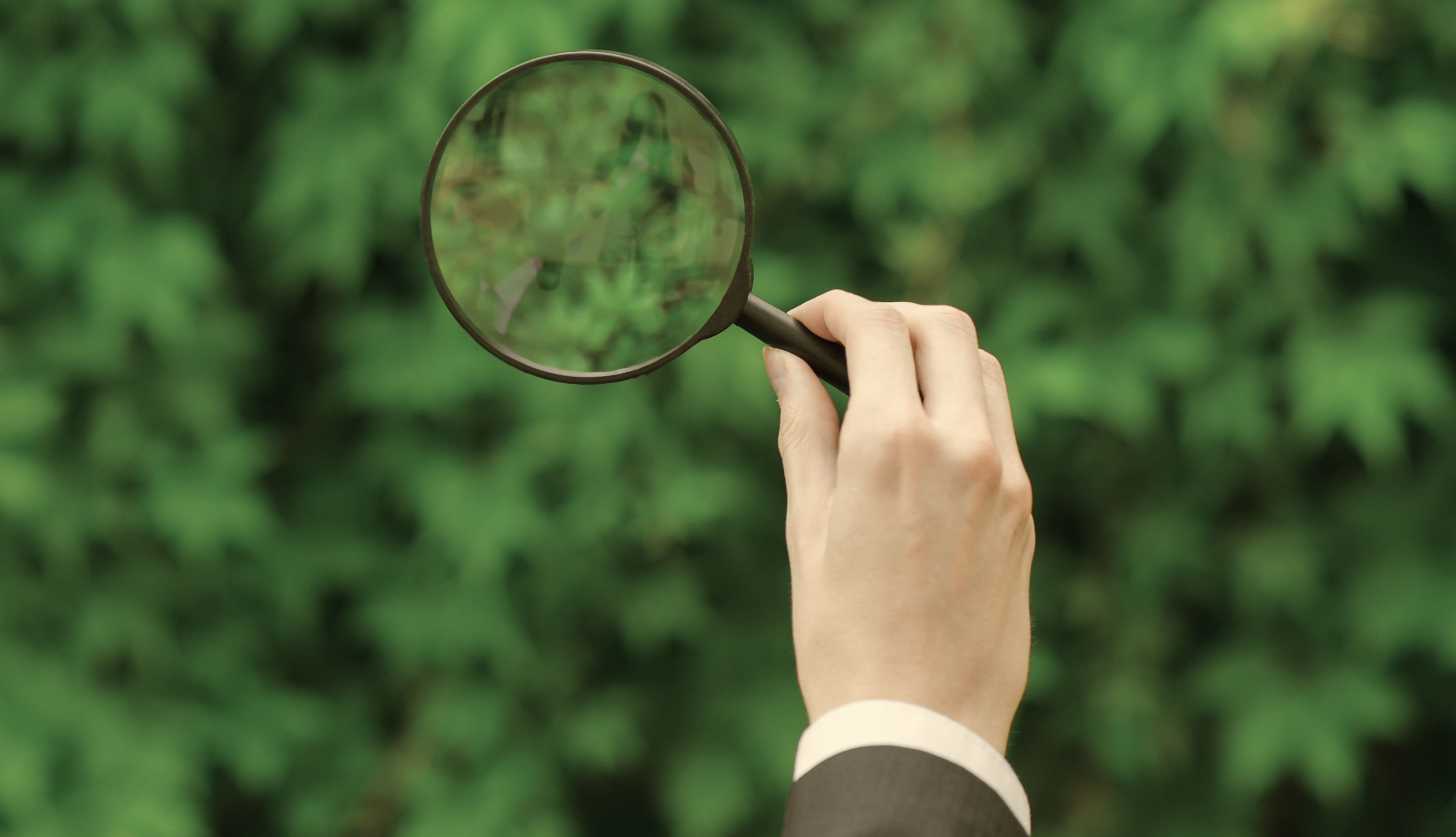 Man looking through a magnifier glass